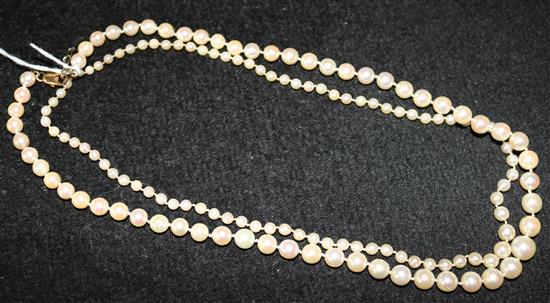 Single row graduated pearl necklace with gold clasp and another with sapphire-set clasp